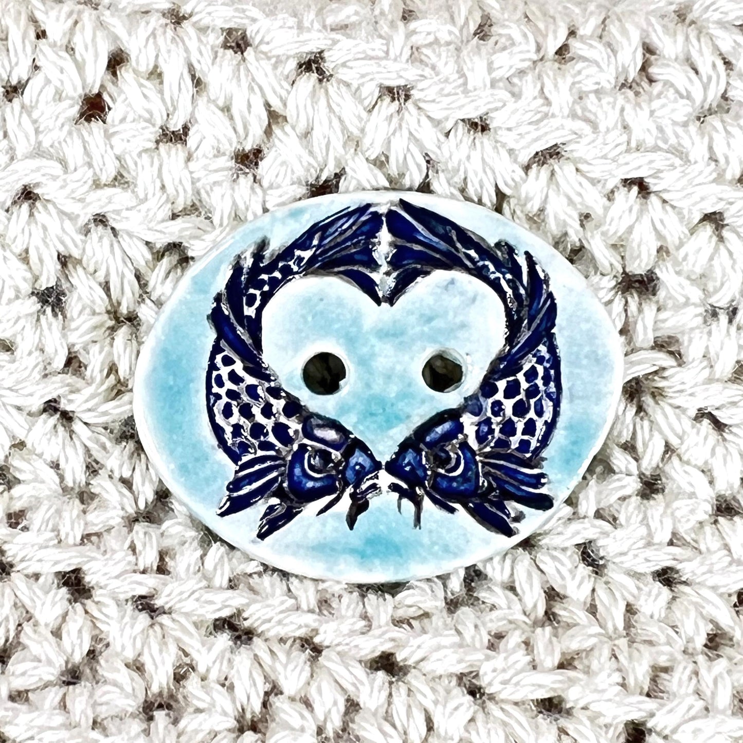 Two Koi Heart with Black Line Work on Light Blue Oval Button