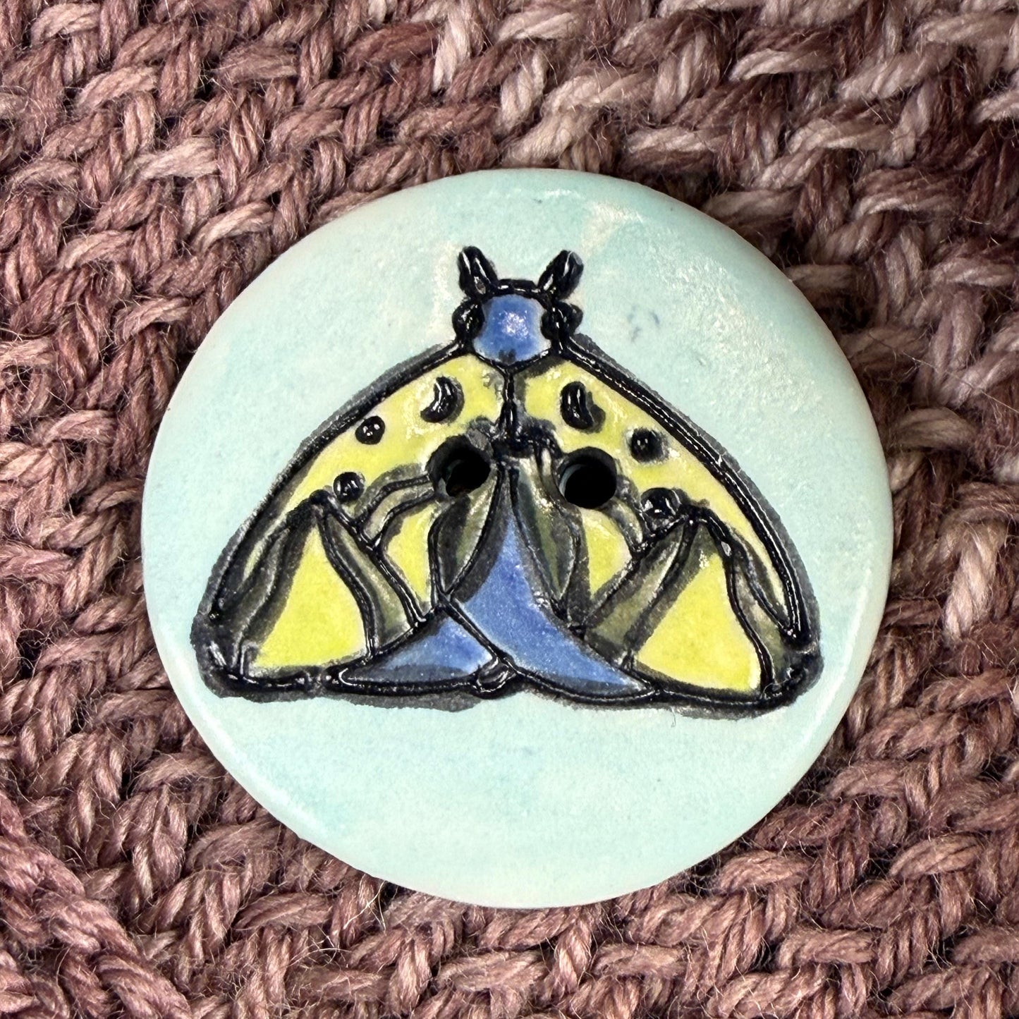 Dark Blue and Chartreuse Moth on Aqua Blue Ceramic Button