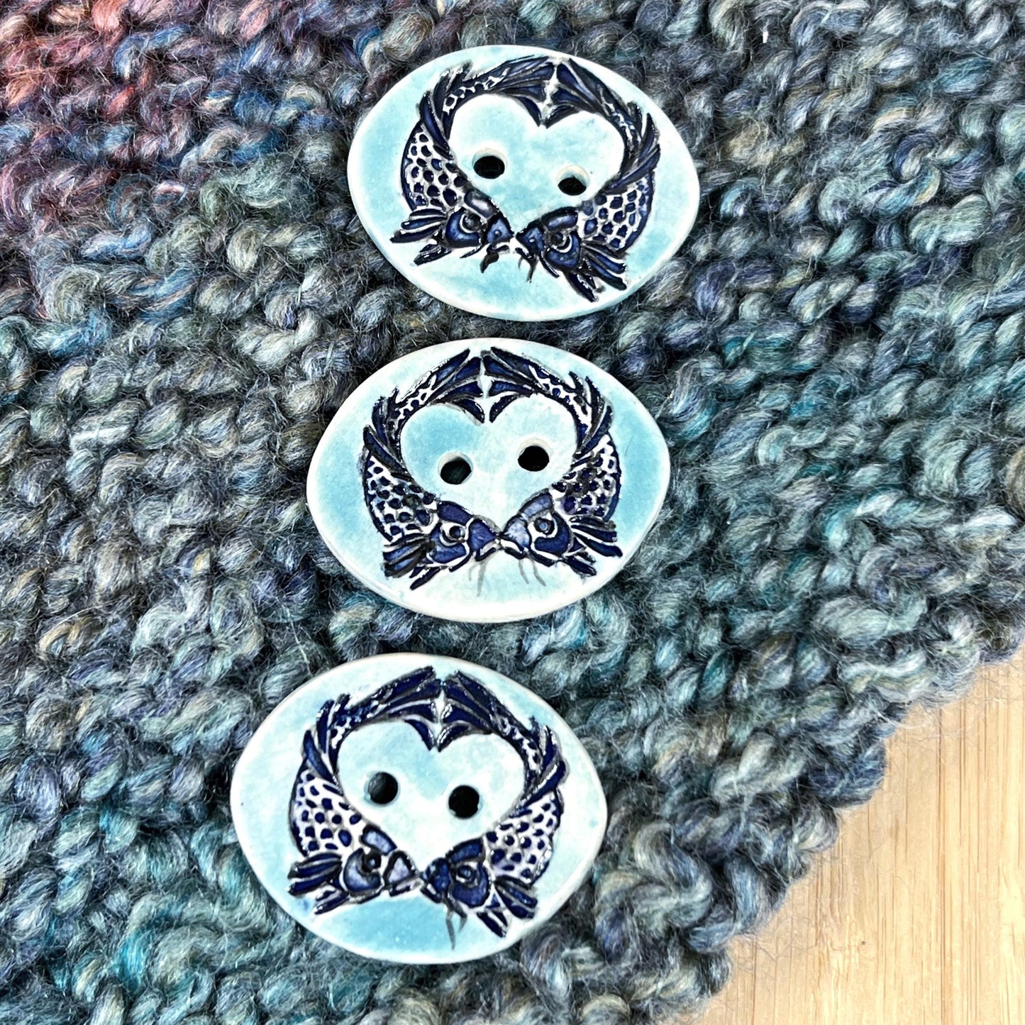 Two Koi Heart with Black Line Work on Light Blue Oval Button