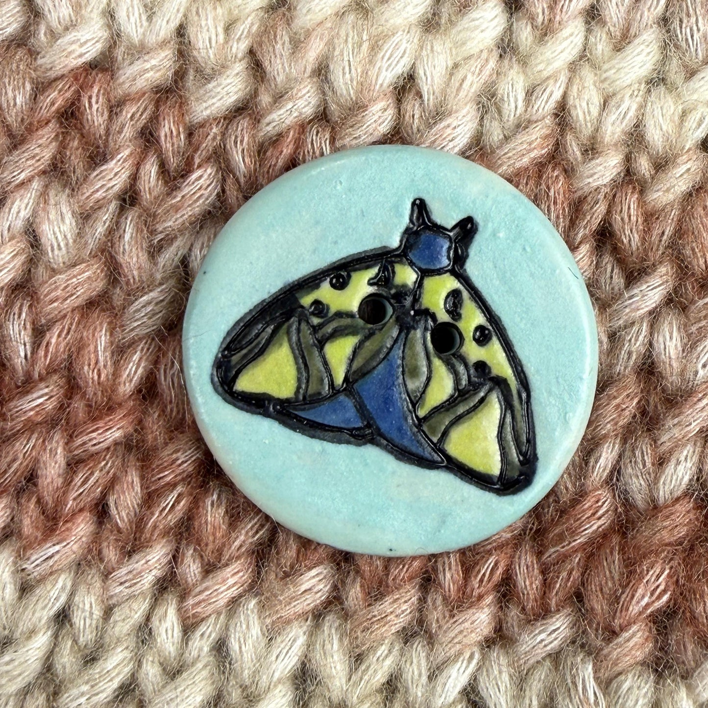Dark Blue and Chartreuse Moth on Aqua Blue Ceramic Button