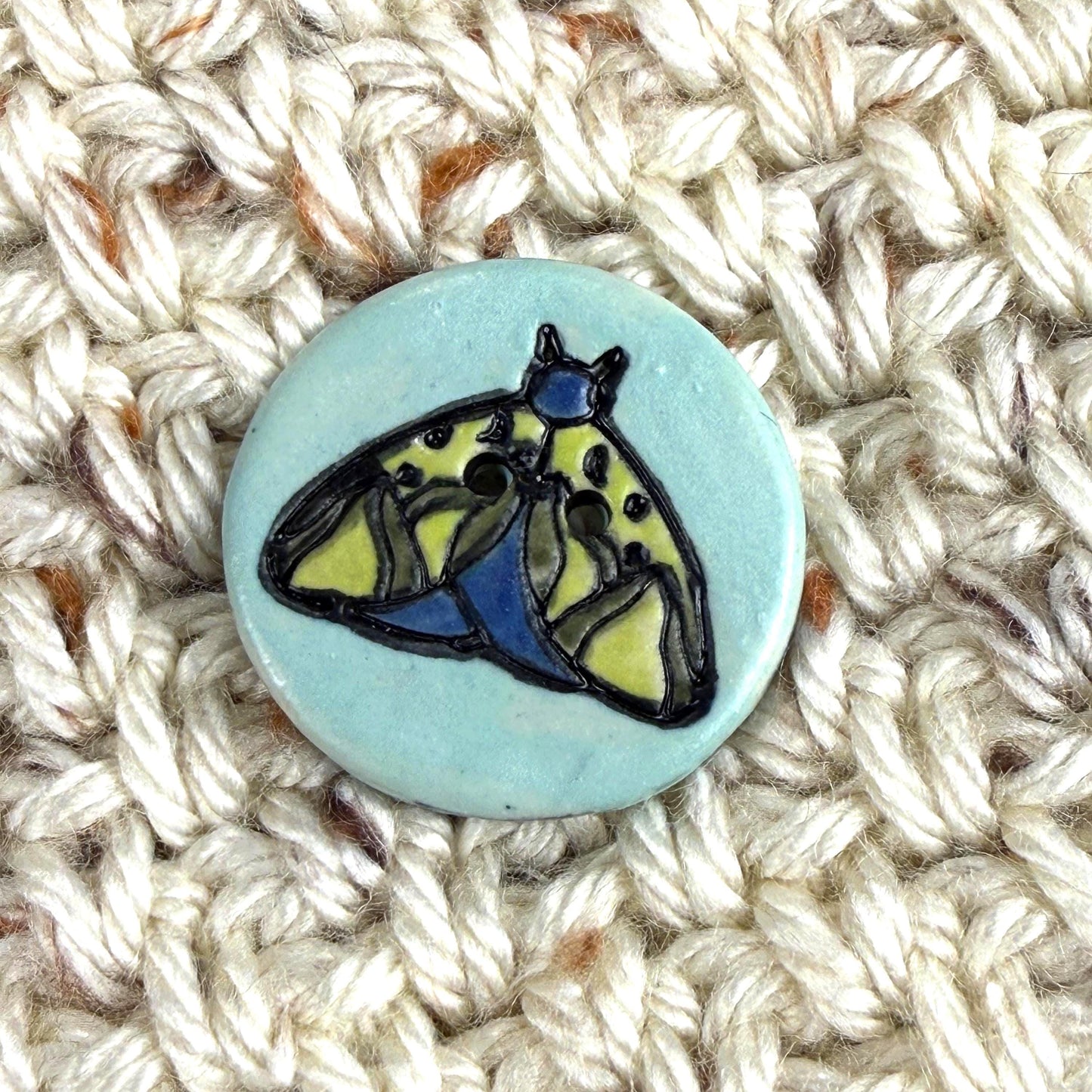 Dark Blue and Chartreuse Moth on Aqua Blue Ceramic Button