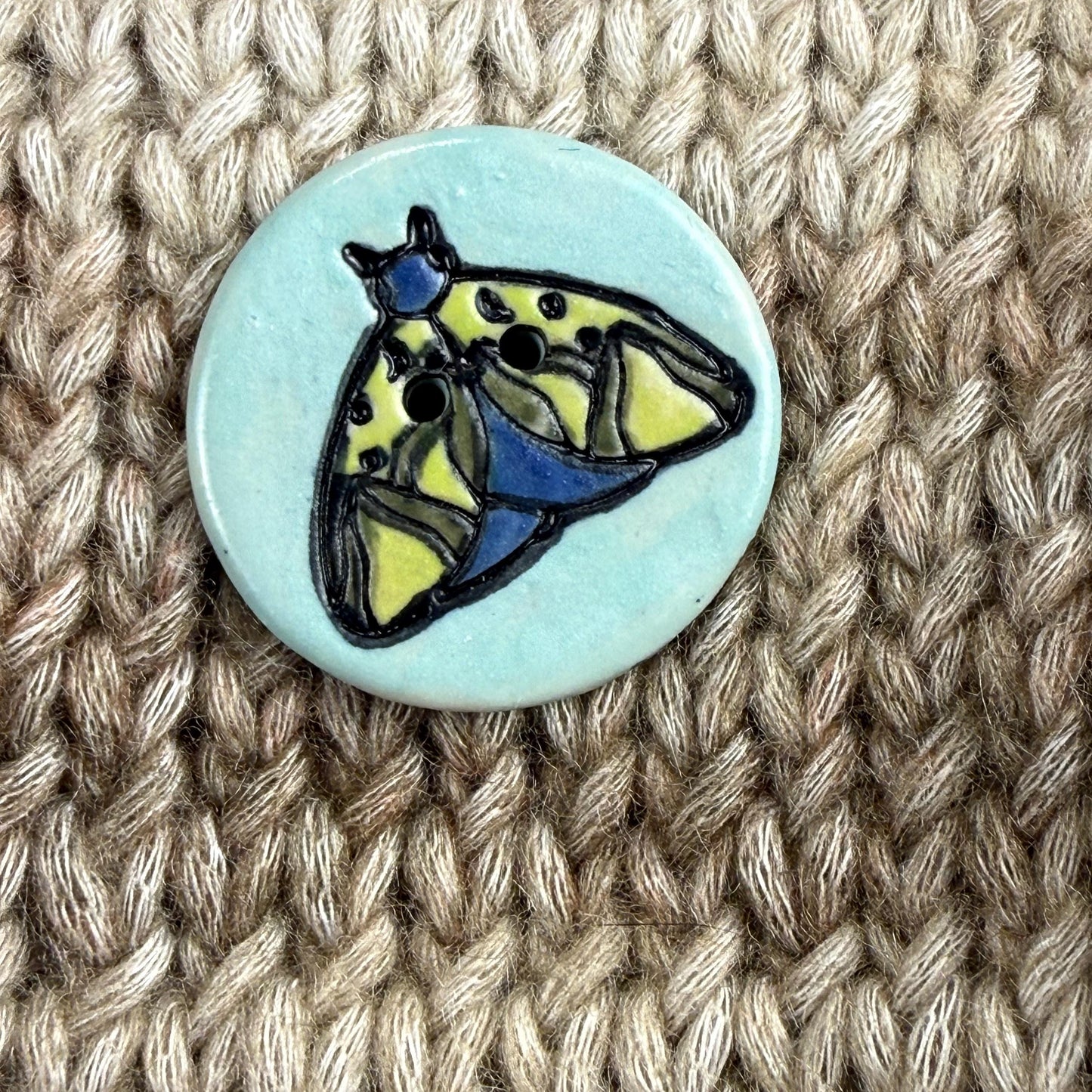 Dark Blue and Chartreuse Moth on Aqua Blue Ceramic Button