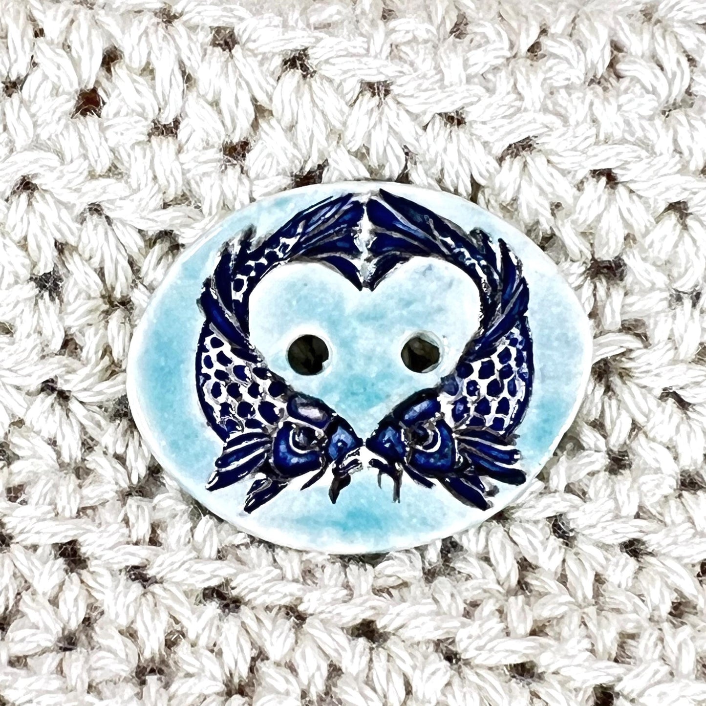 Two Koi Heart with Black Line Work on Light Blue Oval Button