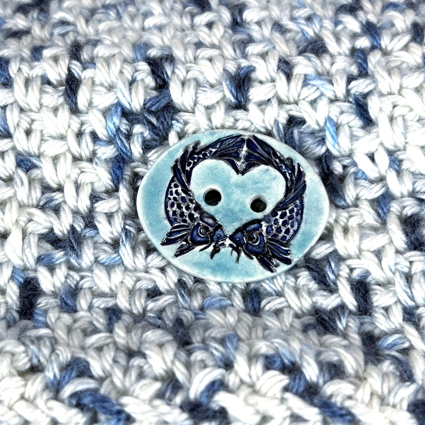 Two Koi Heart with Black Line Work on Light Blue Oval Button