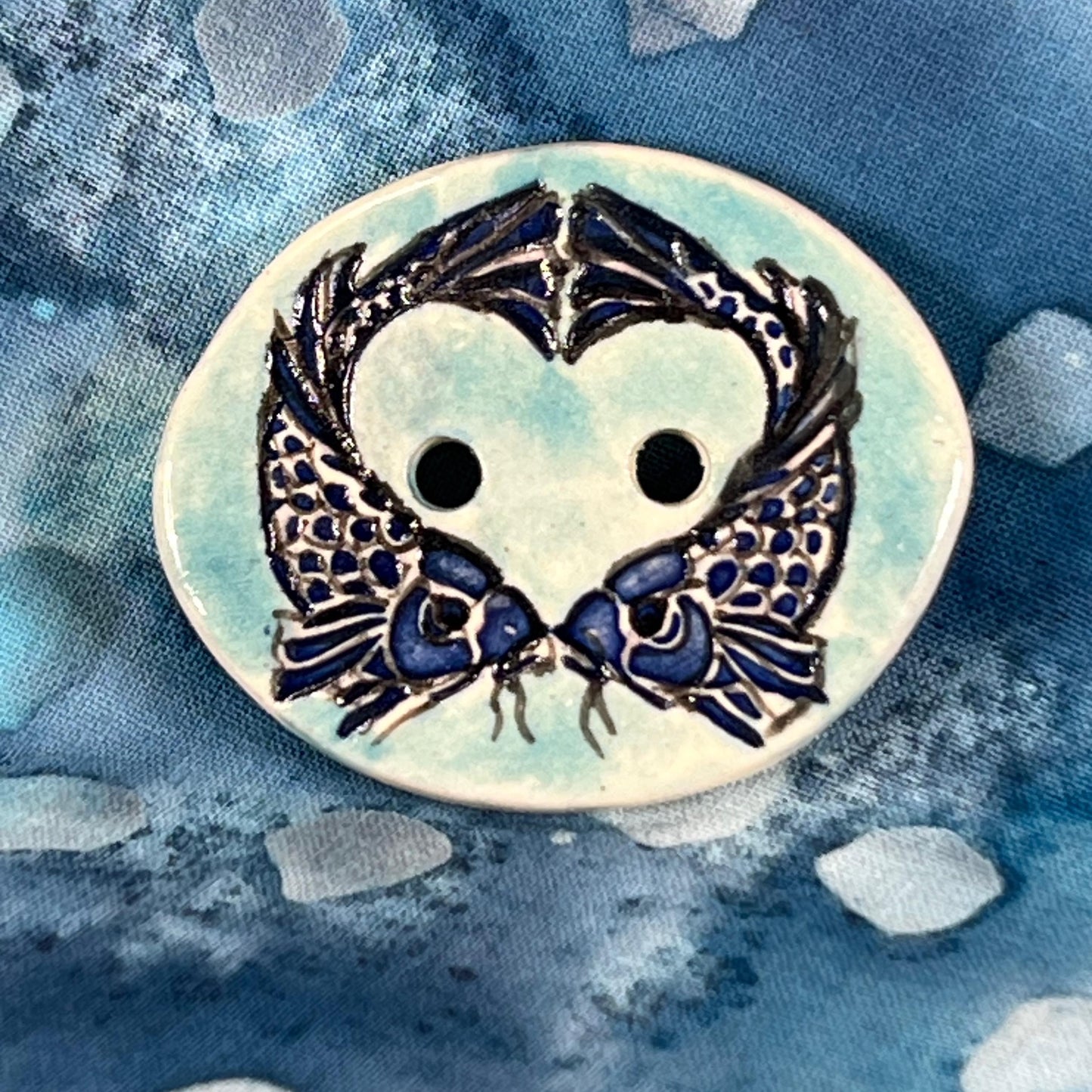 Two Koi Heart with Black Line Work on Light Blue Oval Button
