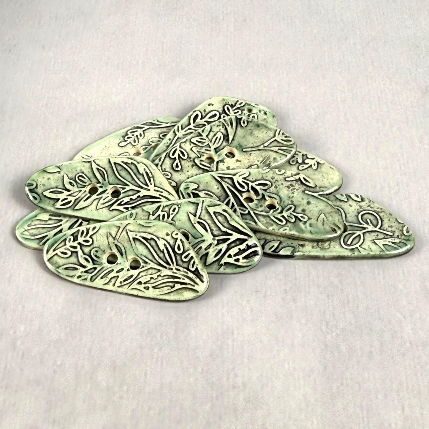 Green Washed Triangular Button with Flower and Plant Texture