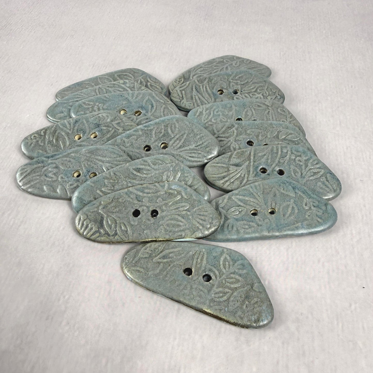 Blue Matte Triangular Button with Flower and Plant Texture
