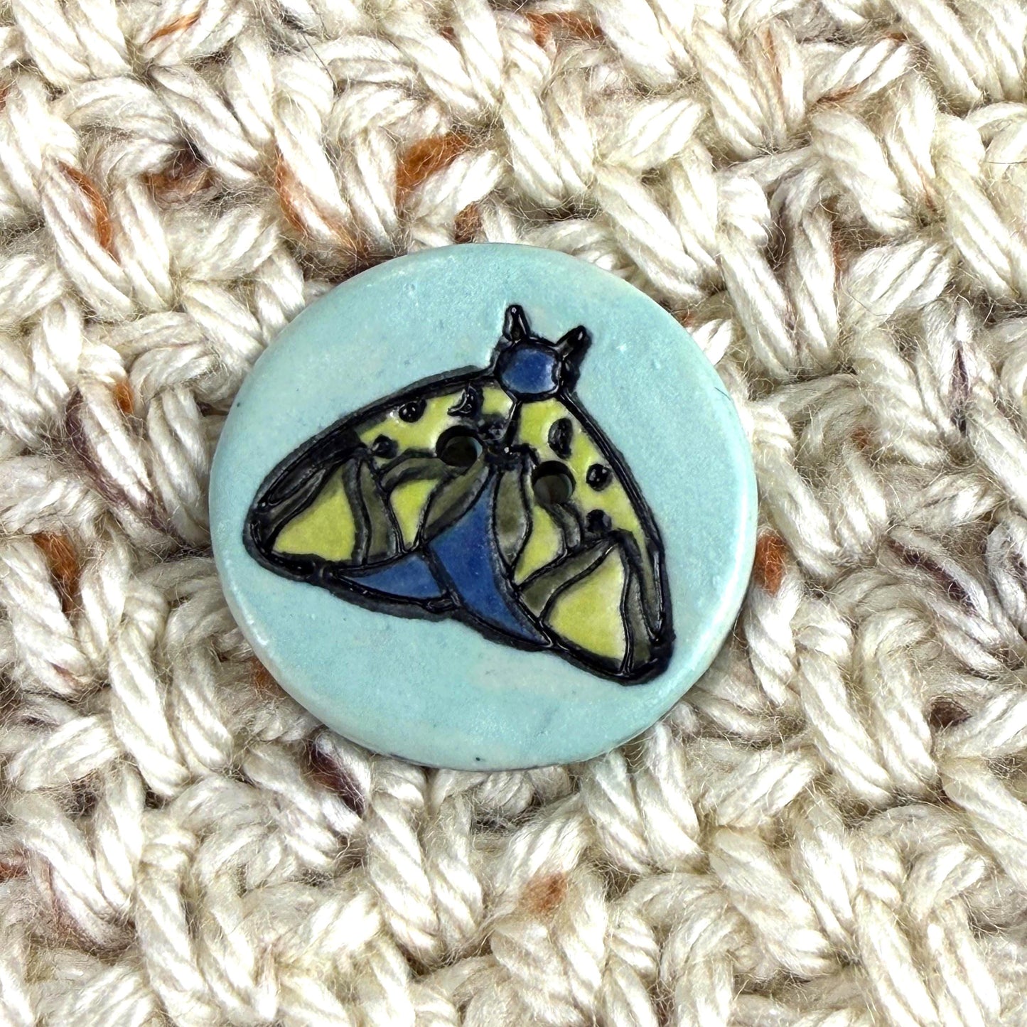 Dark Blue and Chartreuse Moth on Aqua Blue Ceramic Button