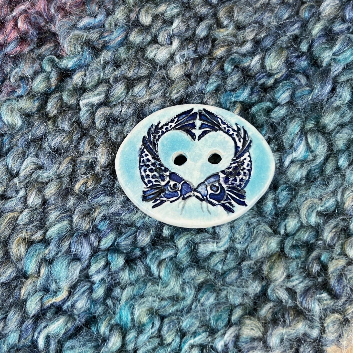 Two Koi Heart with Black Line Work on Light Blue Oval Button