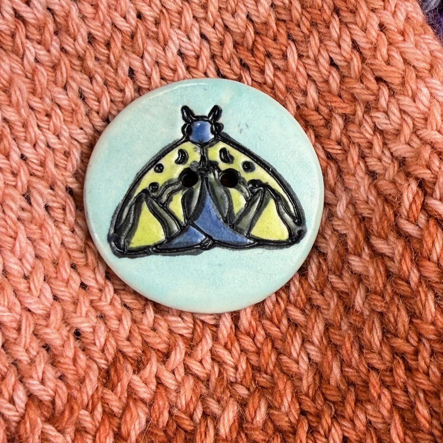 Dark Blue and Chartreuse Moth on Aqua Blue Ceramic Button