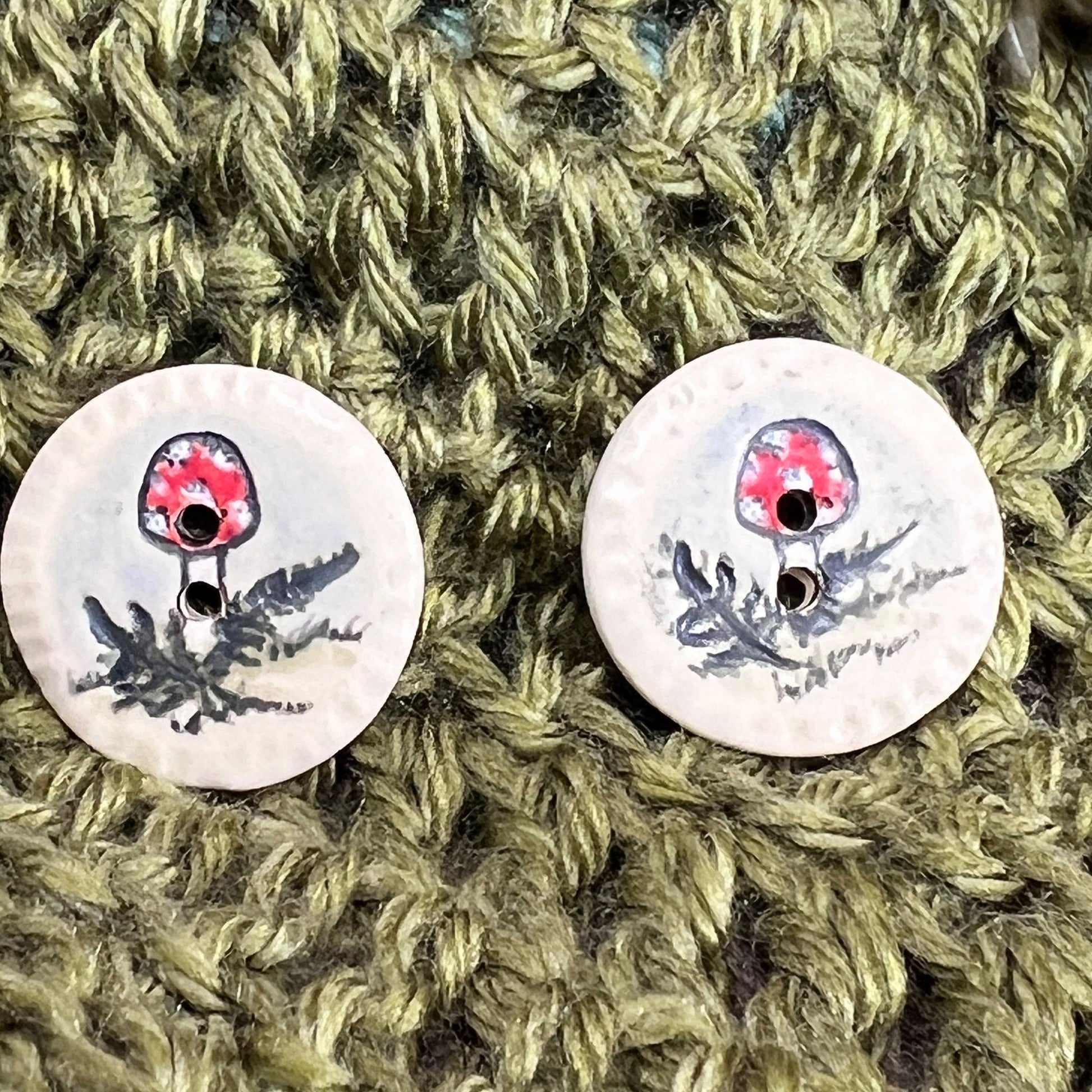 Red and White Cap Mushroom with Fern on White Round Button