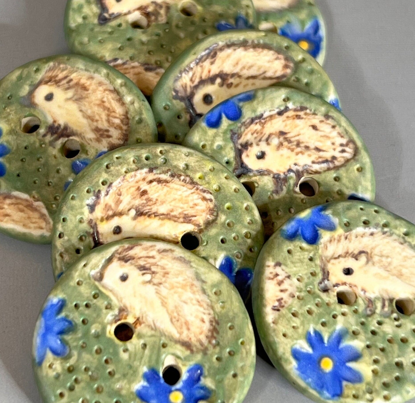 Hedgehog on Green Field with Blue Flowers Round Ceramic Button