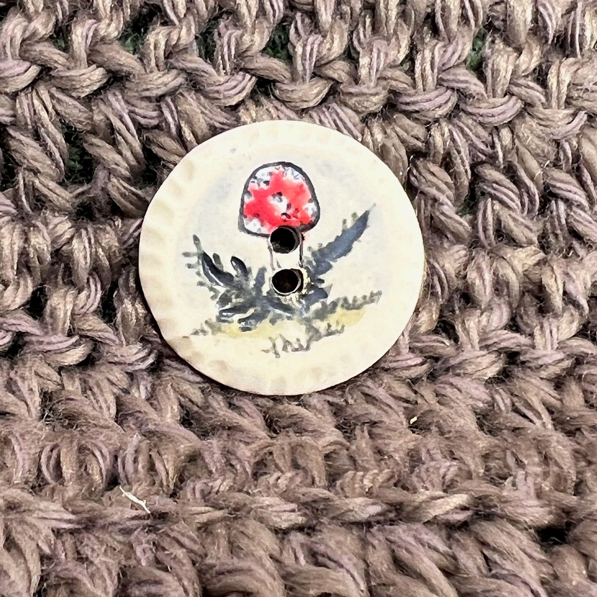 Red and White Cap Mushroom with Fern on White Round Button