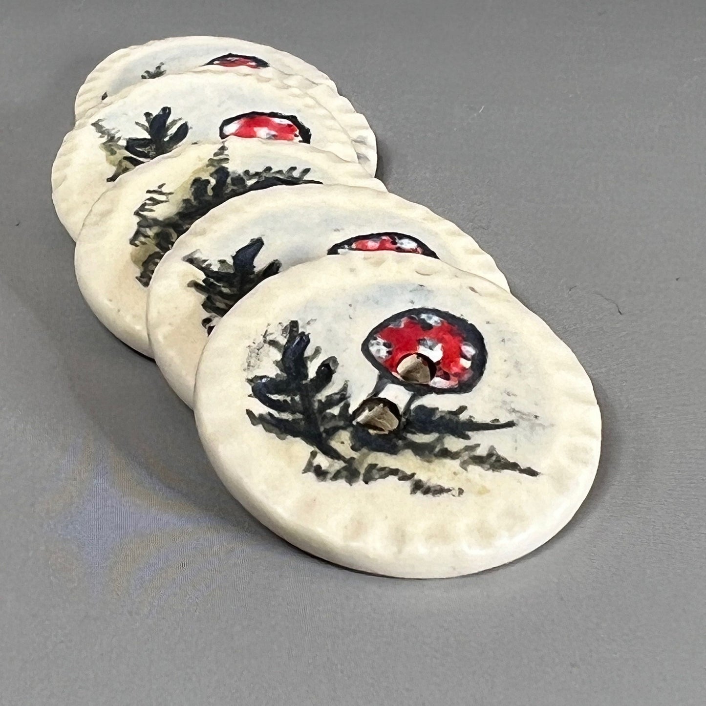 Red and White Cap Mushroom with Fern on White Round Button
