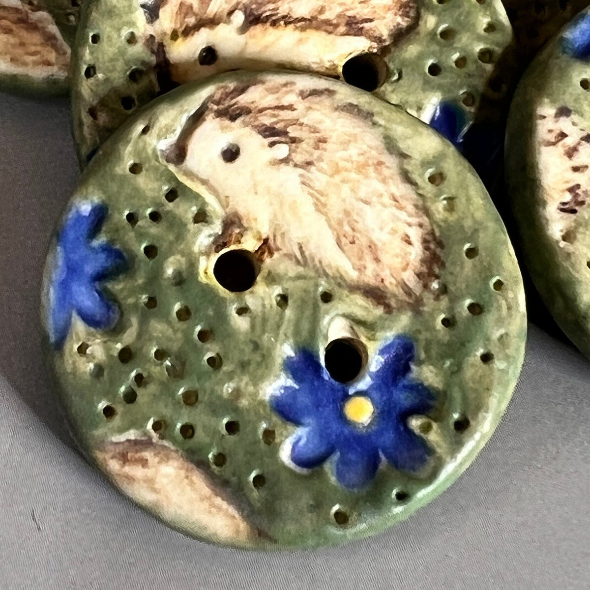 Hedgehog on Green Field with Blue Flowers Round Ceramic Button