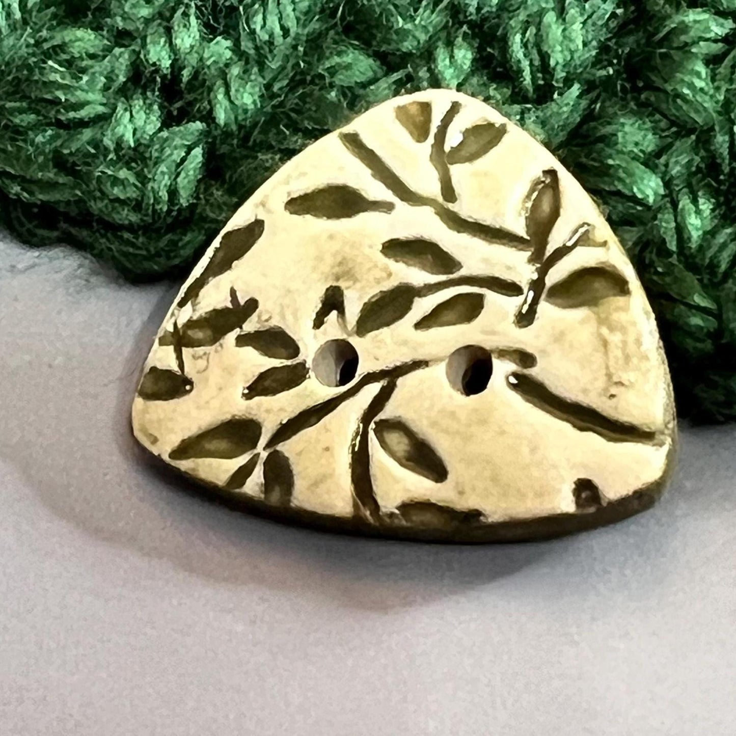 Avocado Green Leaves on Khaki Background Circular Triangle Shaped Ceramic Button