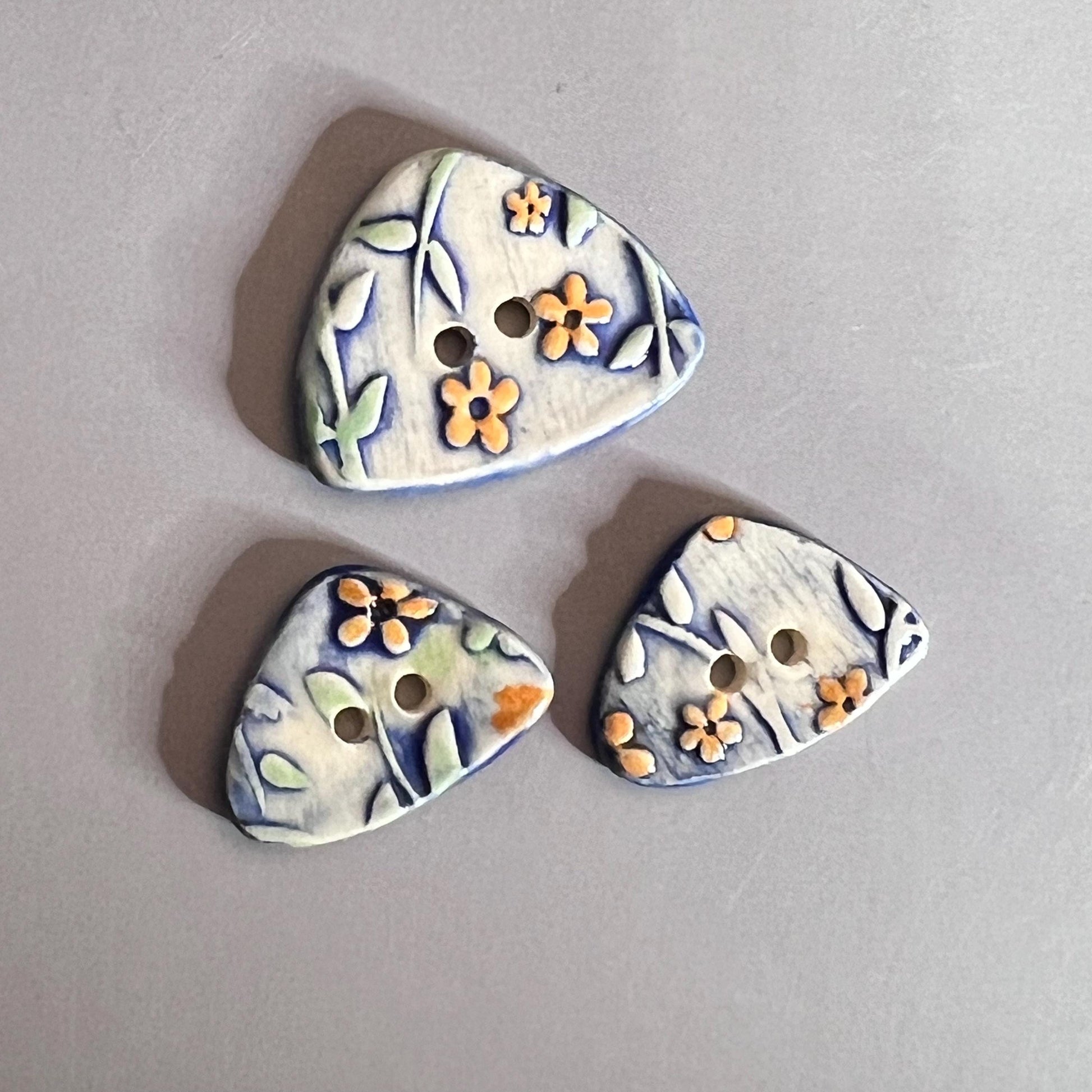 Orange Flowers on Blue and White Background Ceramic Large and Small Triangular Button