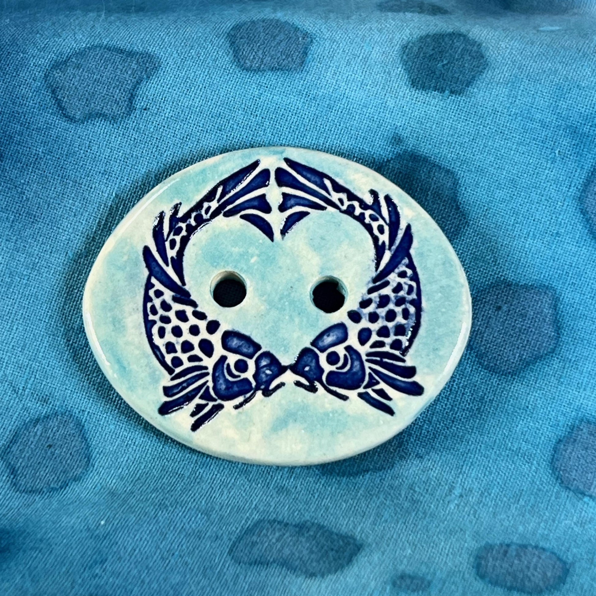 Two Koi Heart on Light Blue Oval Button