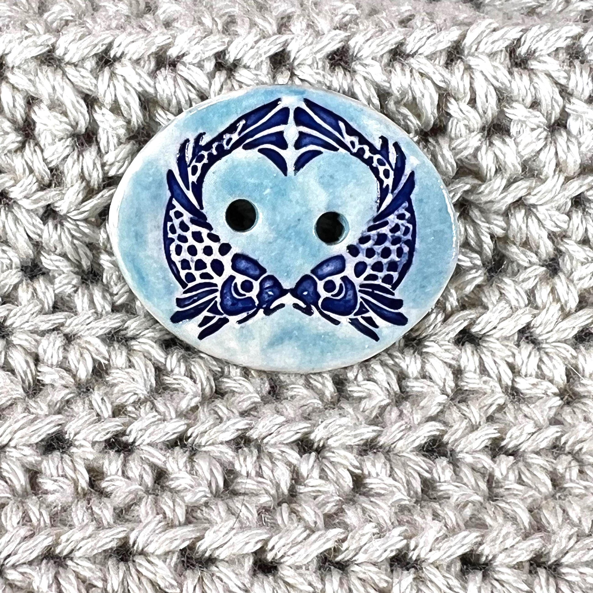 Two Koi Heart on Light Blue Oval Button