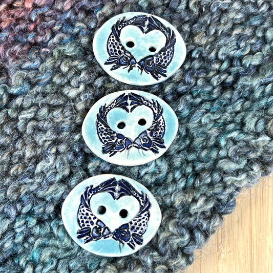 Two Koi Heart with Black Line Work on Light Blue Oval Button