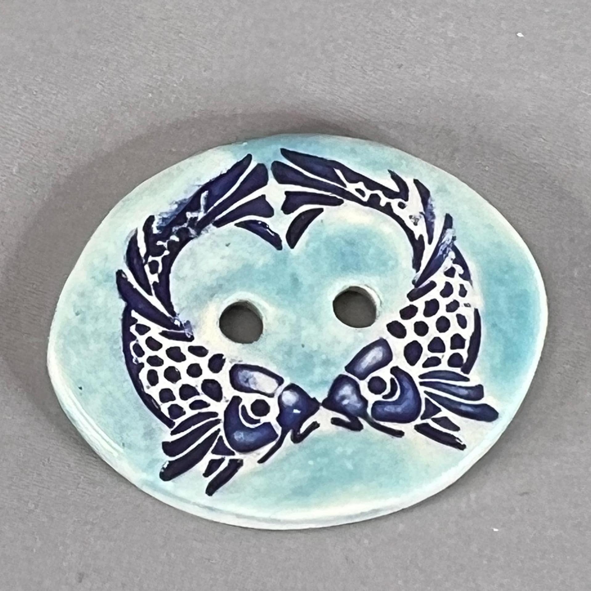 Two Koi Heart on Light Blue Oval Button
