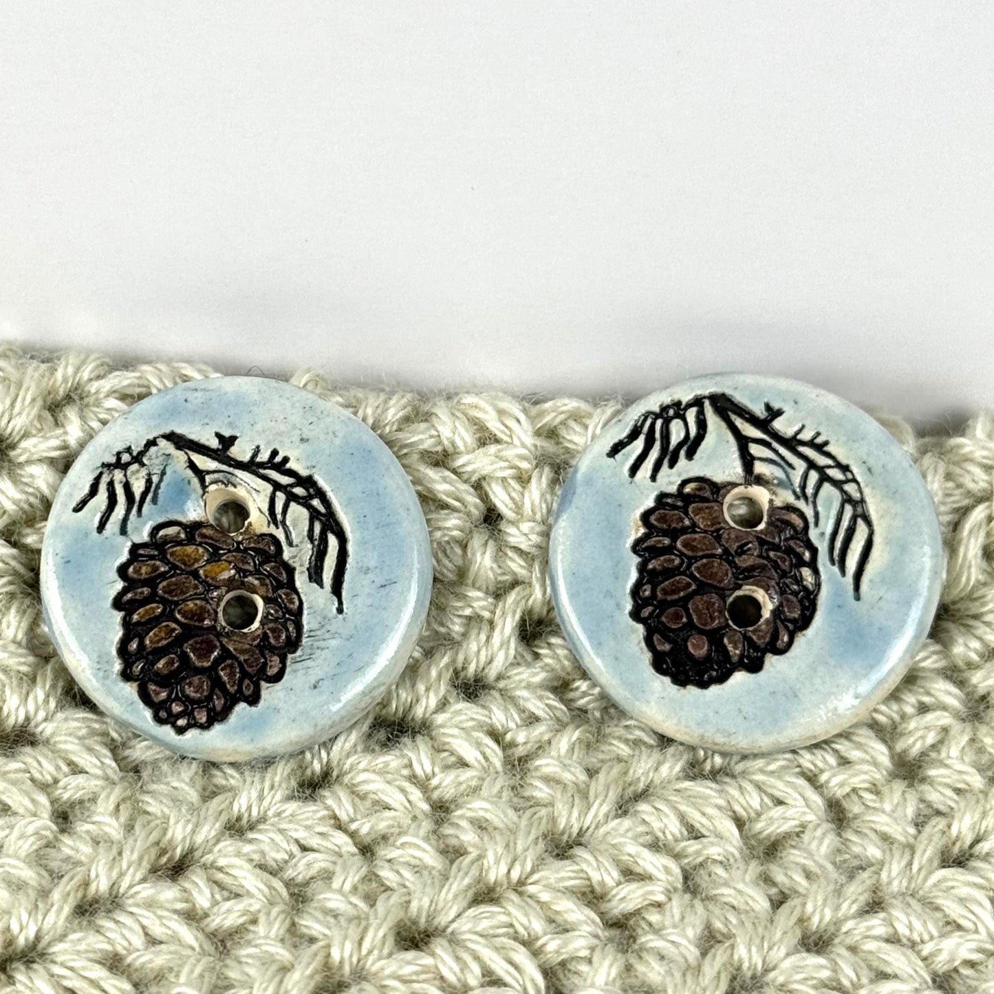 Pinecone with Pine Branch on Blue Round Ceramic Buttons