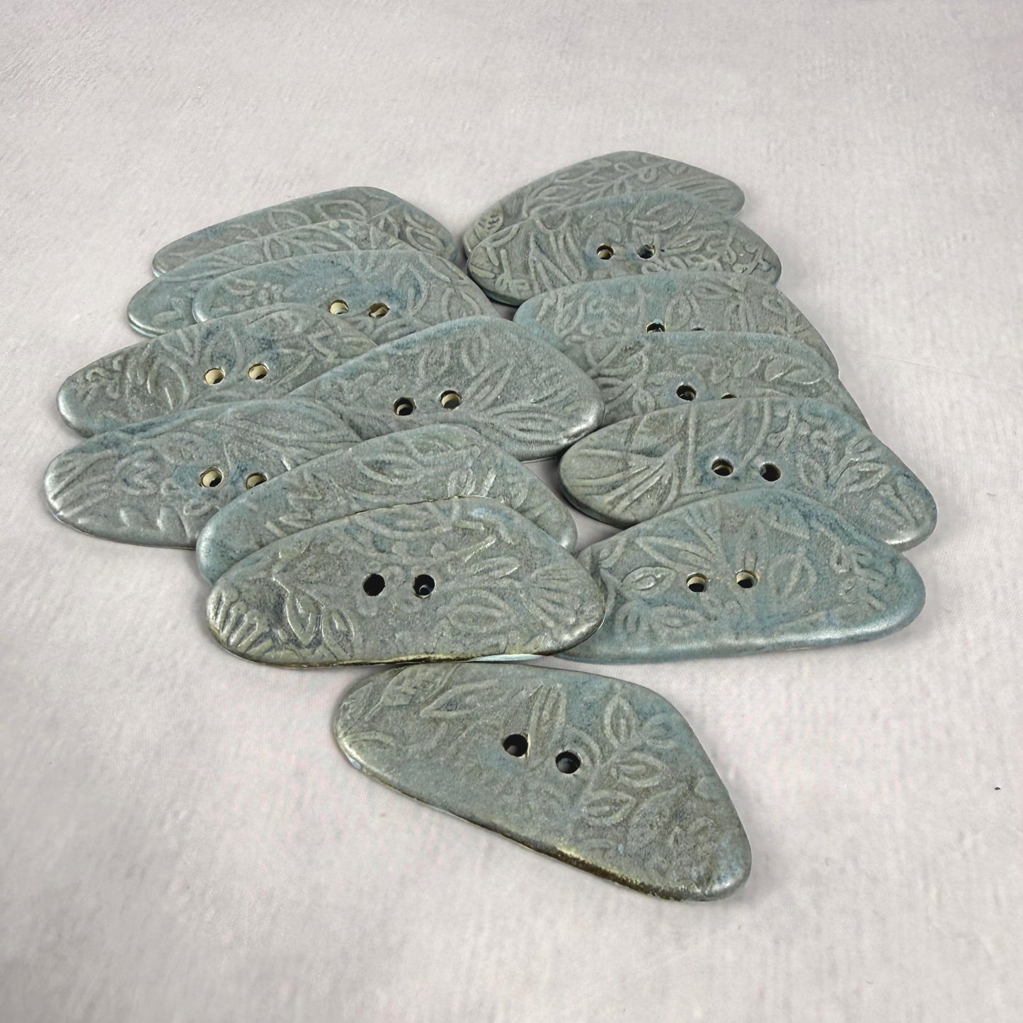 Blue Matte Triangular Button with Flower and Plant Texture