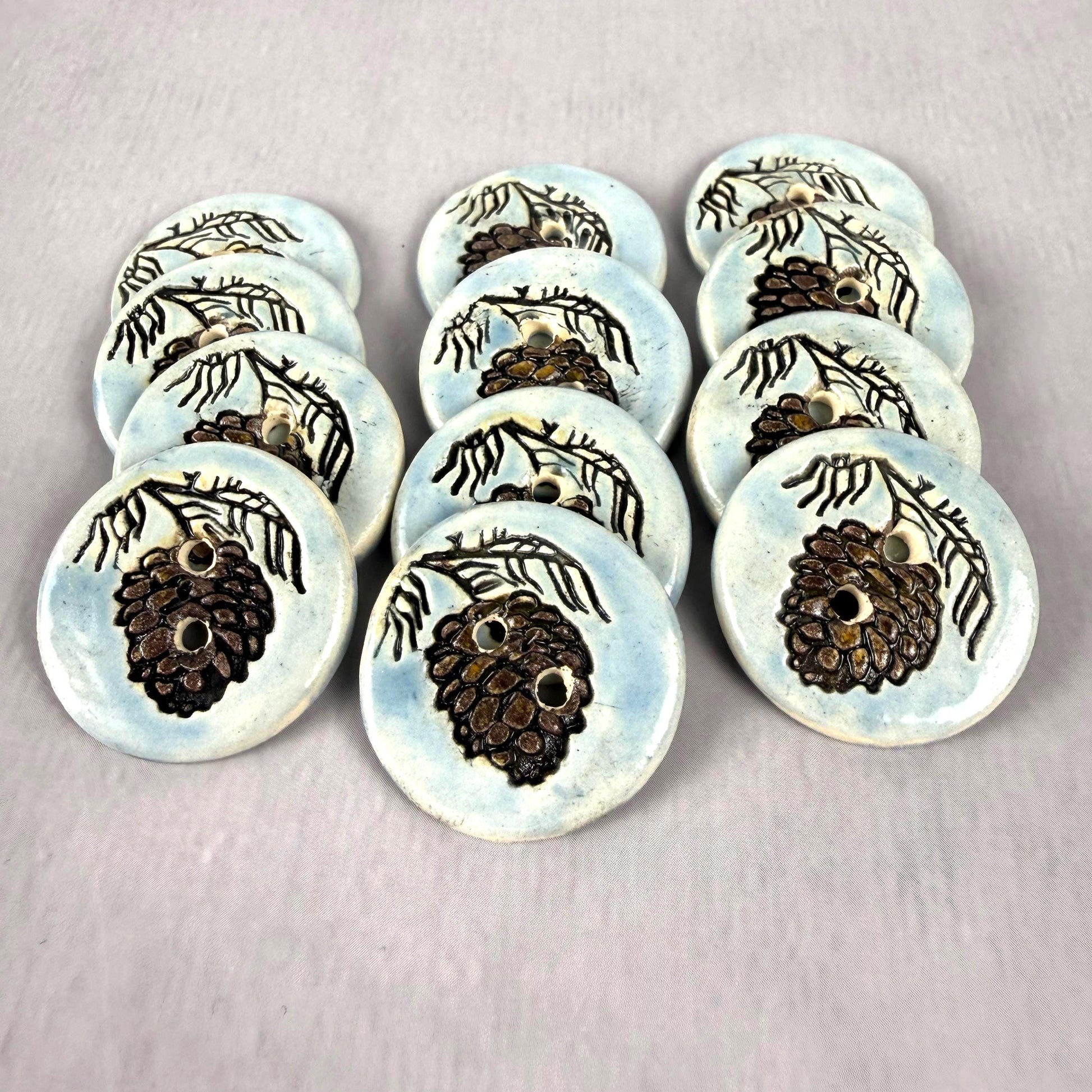 Pinecone with Pine Branch on Blue Round Ceramic Buttons