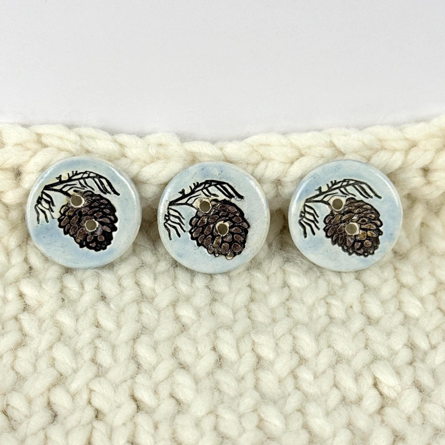 Pinecone with Pine Branch on Blue Round Ceramic Buttons