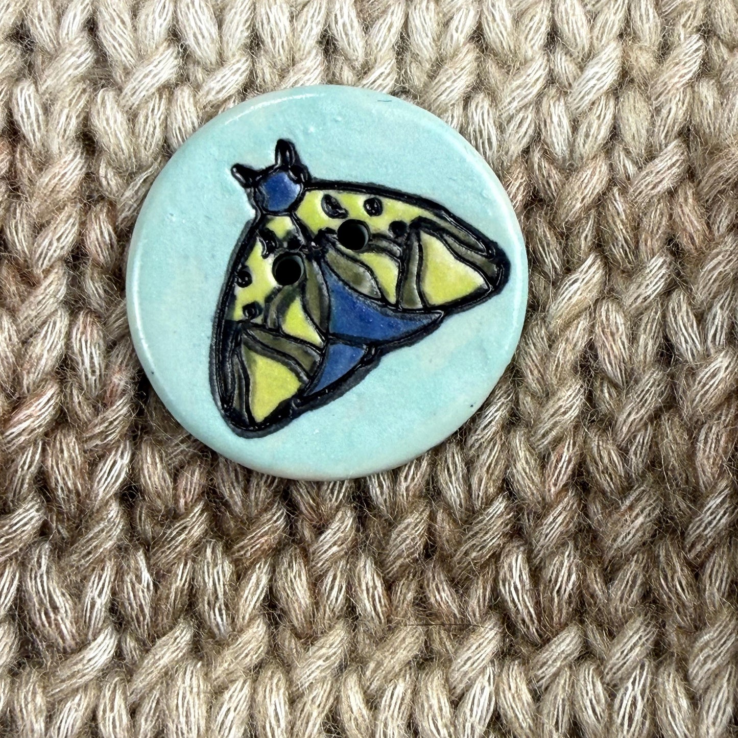Dark Blue and Chartreuse Moth on Aqua Blue Ceramic Button