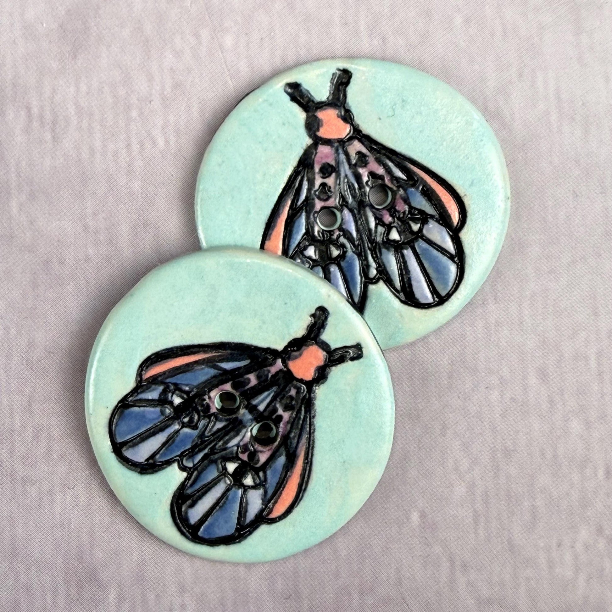 Blue Moth with Eyes on Aqua Blue Ceramic Button