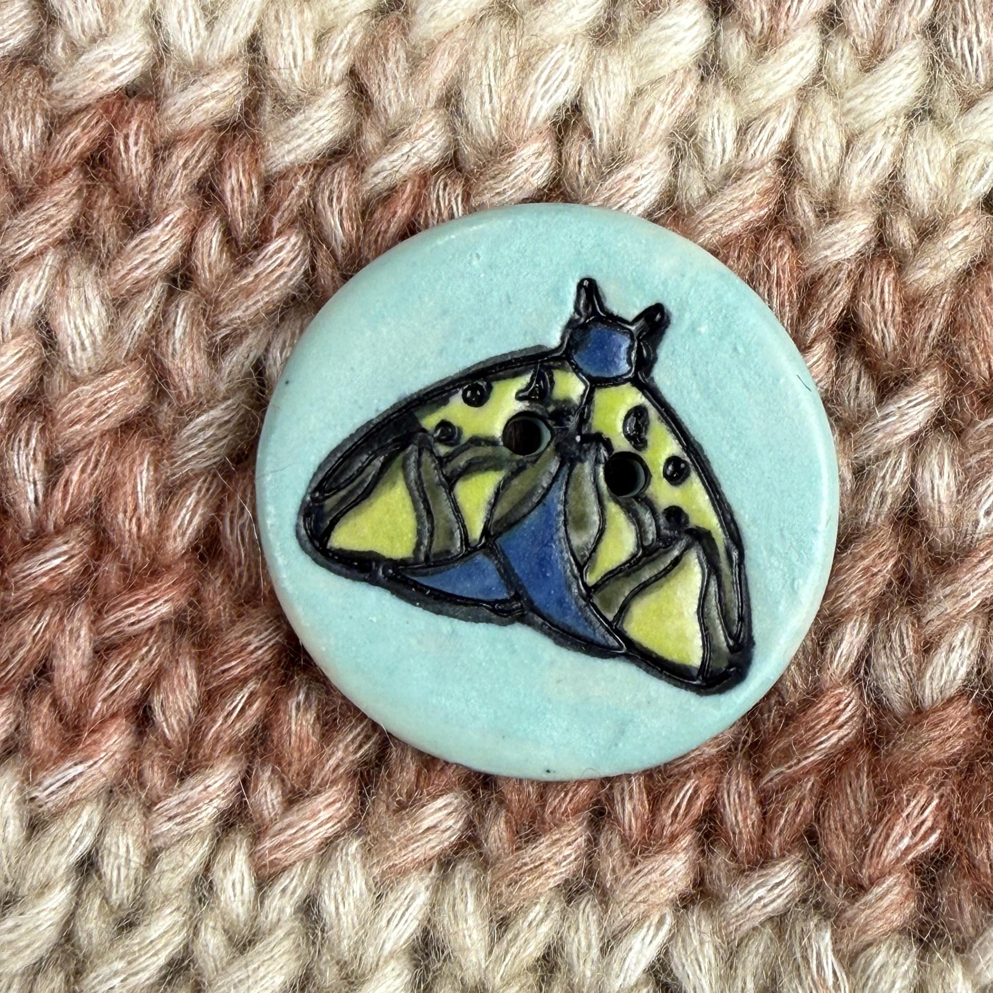 Dark Blue and Chartreuse Moth on Aqua Blue Ceramic Button