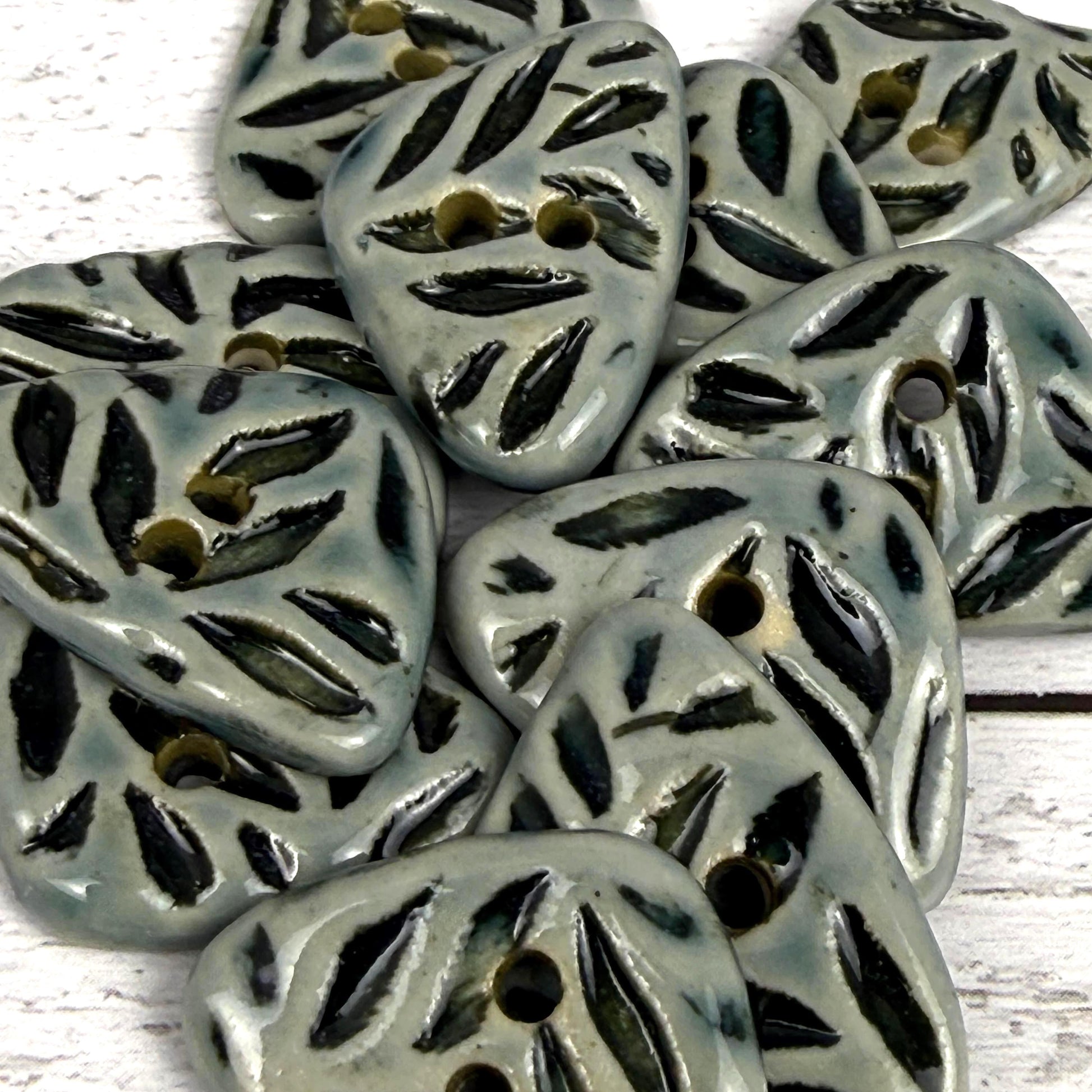 Small Triangular Shaped Buttons in Light Sage with Dark Sage Leaf Pattern