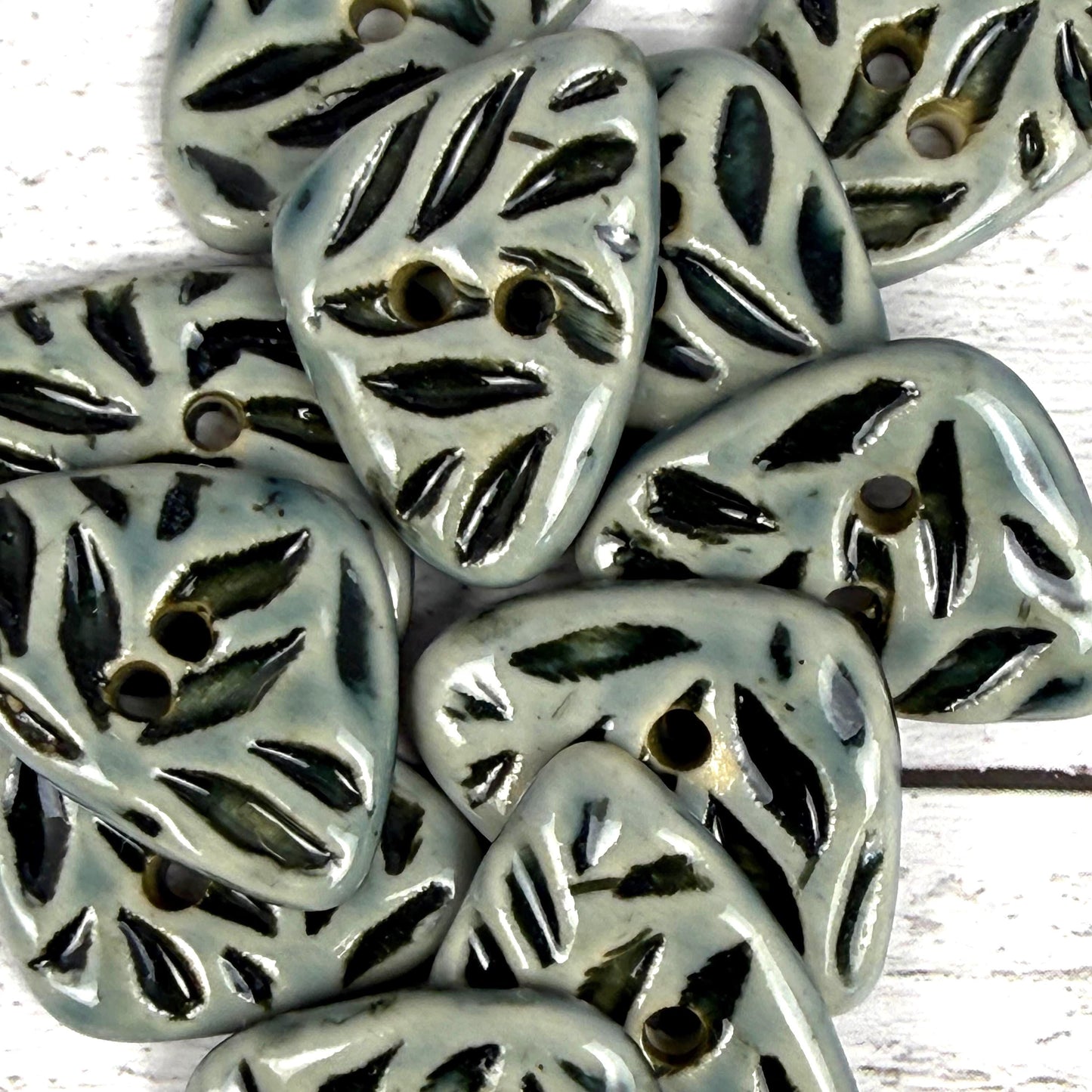 Small Triangular Shaped Buttons in Light Sage with Dark Sage Leaf Pattern
