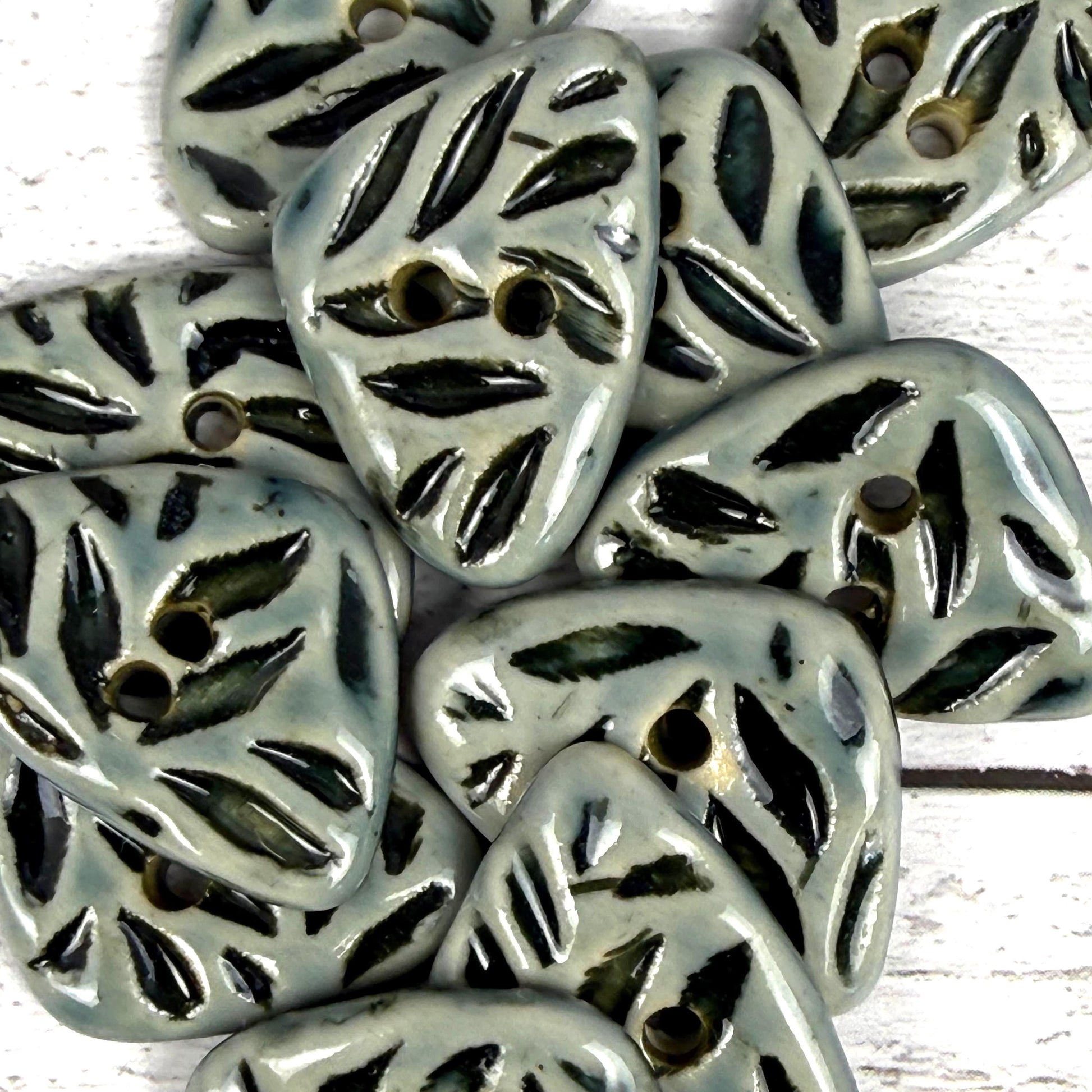 Small Triangular Shaped Buttons in Light Sage with Dark Sage Leaf Pattern